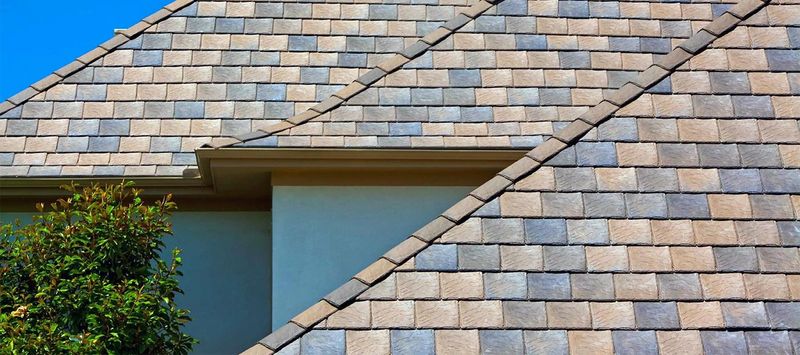 A roof in blended tan and grey shingles