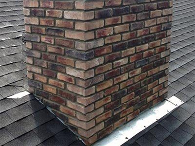 A brick chimney with new step flashing