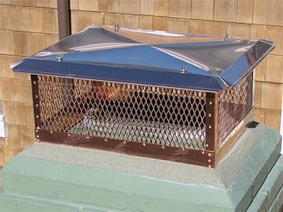 A copper cap with a mesh screen on a concrete crown