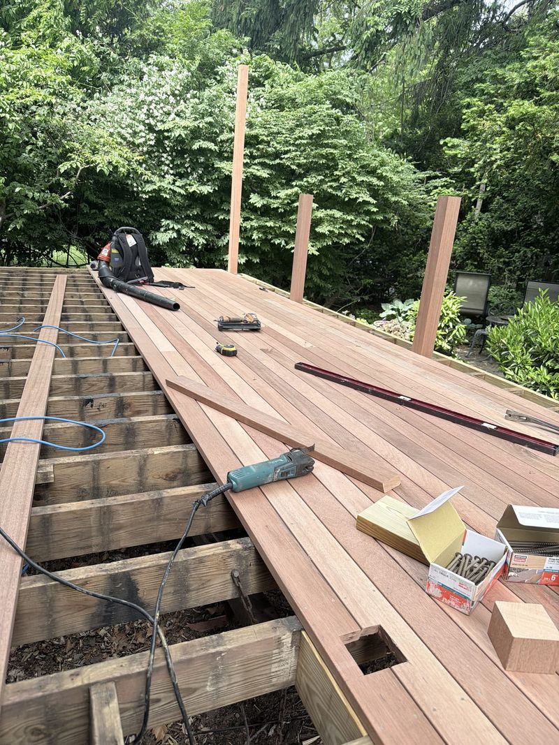 A deck being built, with new boards going down over the framing