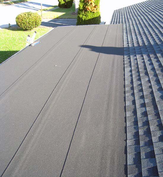 A flat roof membrane meeting a shingle roof