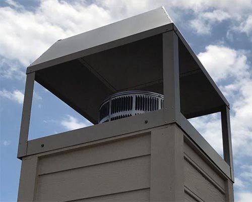 A large metal chimney cap seen from below