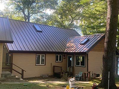 A brown metal roof with skylights