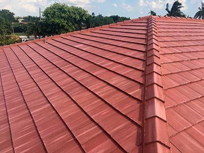Red metal shingles on a hip roof