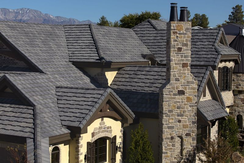 A slate-style roof with a tall stone chimney