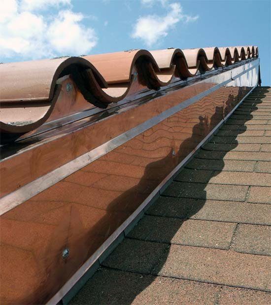 Metal flashing along a tile roof