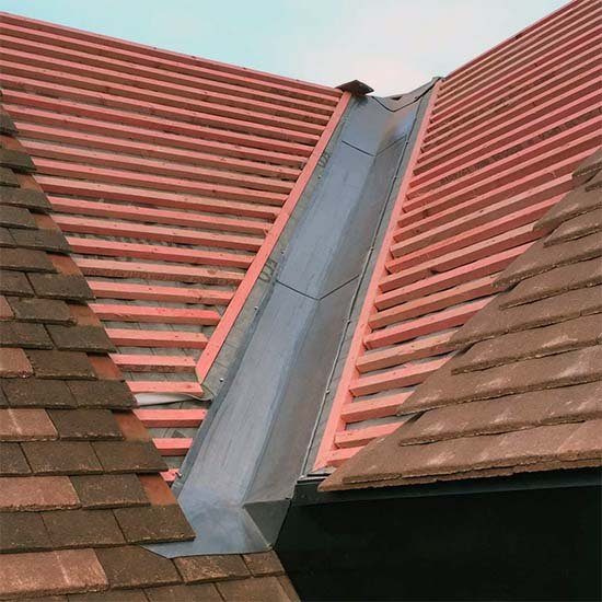 Valley flashing between two tile roofs